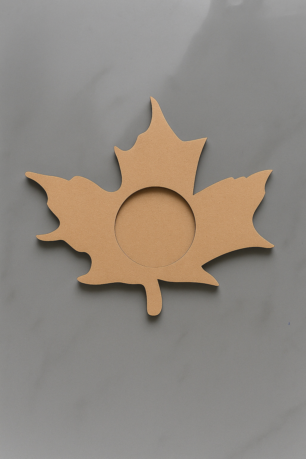 MDF  leaf-shaped tealight candle holder on a gray background