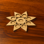 Leaf-shaped MDF tea light holder with multiple tealights lit on wooden surface