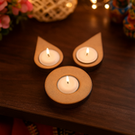 Three lit candles in wooden holders on a wooden surface with blurred background