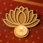 MDF lotus-shaped candle holder with a lit candle on a red fabric background.