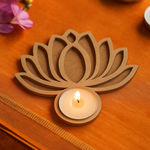 MDF lotus candle holder with a lit candle on an orange fabric background
