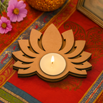 MDF lotus-shaped candle holder with a lit candle on a decorative fabric background