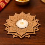 Decorative mdf tealight candle holder with a lit candle on a wooden surface