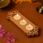 Floral border MDF tealight candle holder with three lit candles for festive home decoration