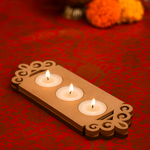 Floral border MDF tealight candle holder with three lit candles for festive home decoration