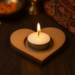 Heart-shaped mdf telight candle holder with a lit candle on a wooden surface