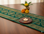 Decorative table runner with a handpainted mdf tealight candle holder and flowers on a wooden table
