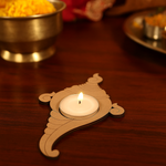 Decorative mdf tealight candle holder with a lit candle on a wooden surface