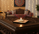 Decorative mdf tealight candle holder on a wooden table with string lights and a colorful wall hanging in the background