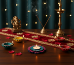 Decorative setup with colorful Diwali lamps, a statue of Ganesha, and incense sticks on a wooden surface with mdf tealight candle holder.