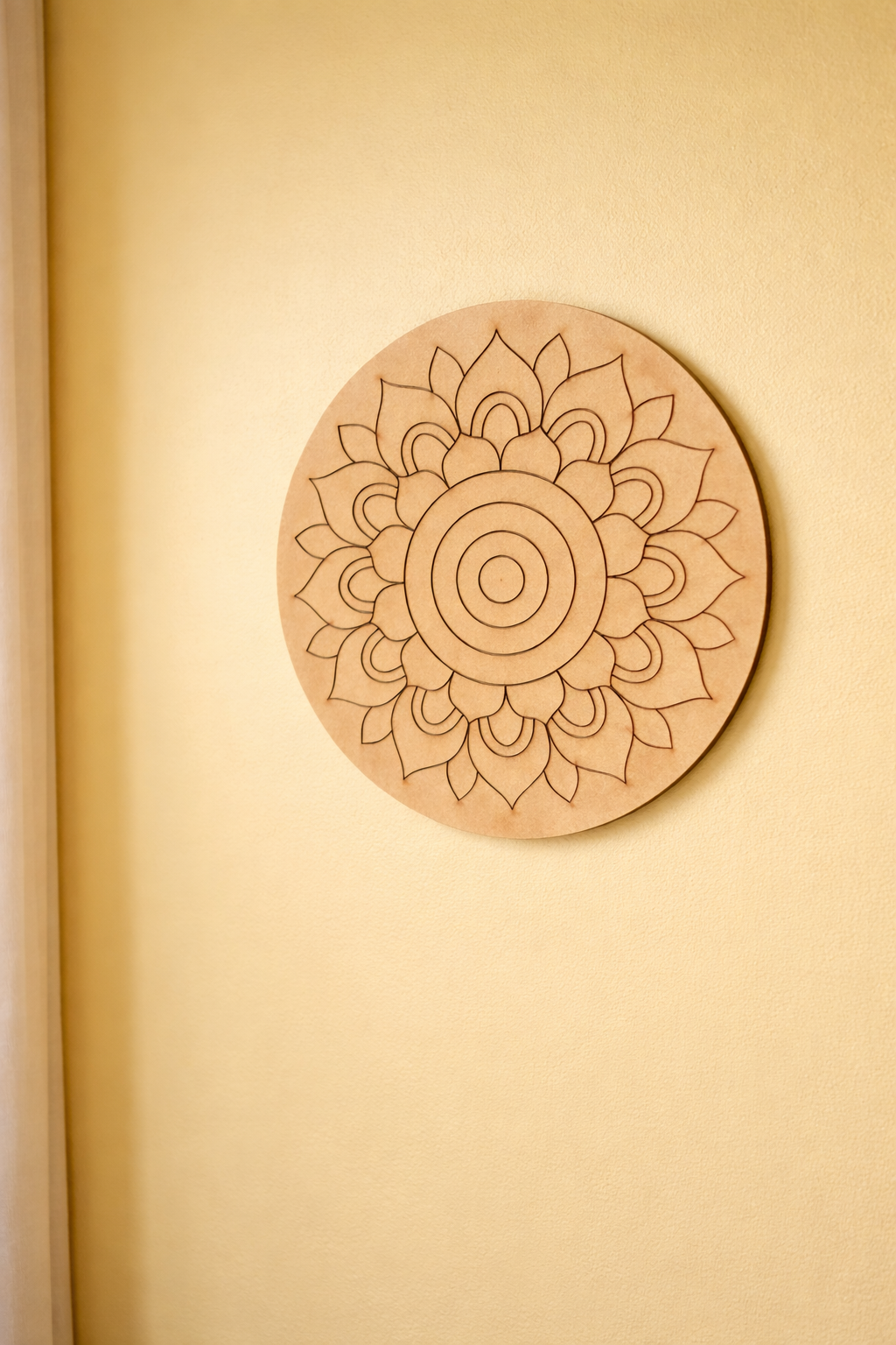MDF DIY circular wall art with a mandala design on a beige wall.