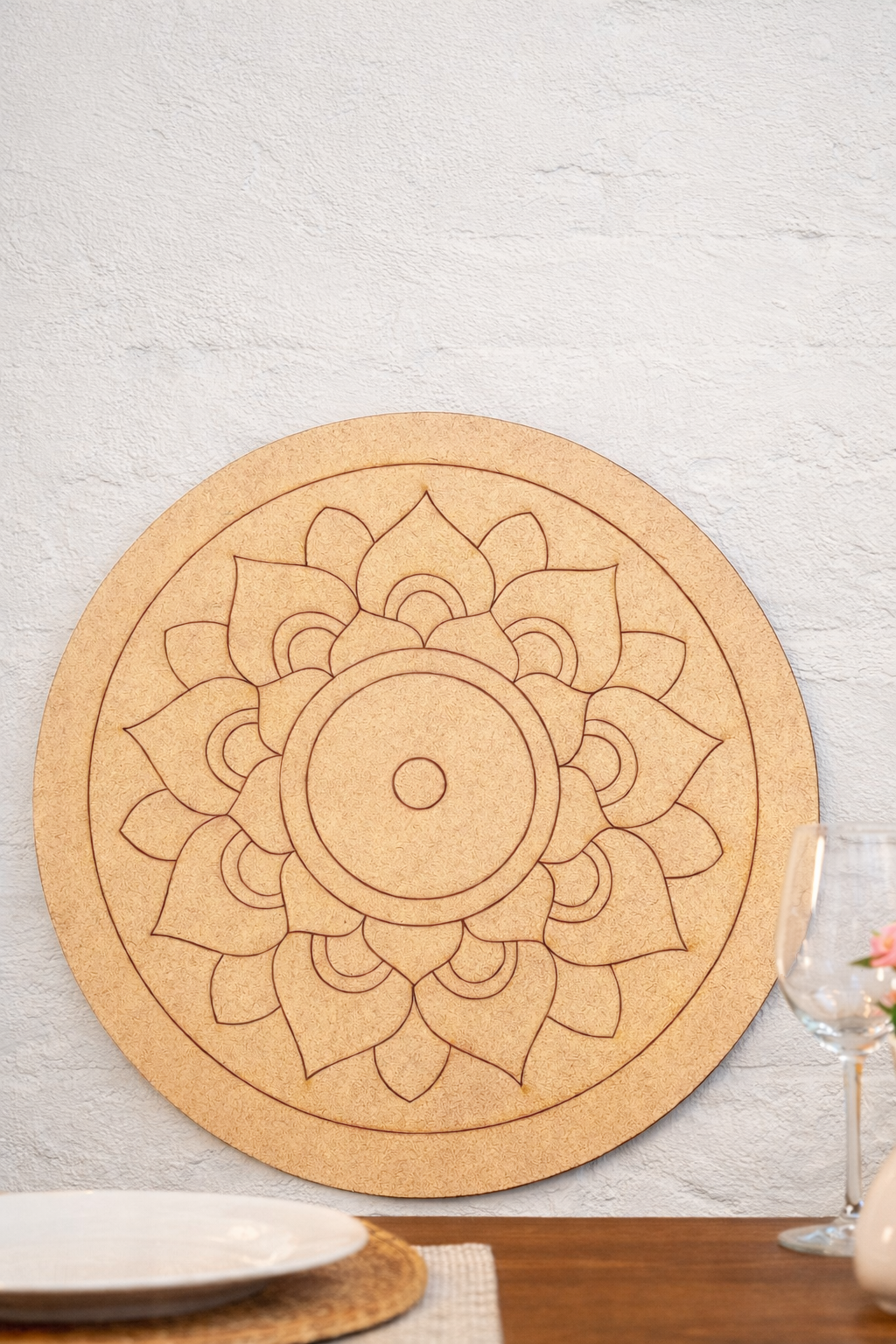Round MDF DIY  mandala with floral design on a wooden table.