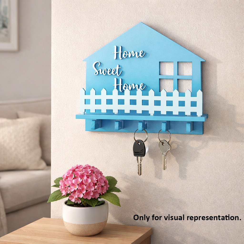 Blue house-shaped MDF key holder with 'Home Sweet Home' text on a wall, next to a pink flower pot.