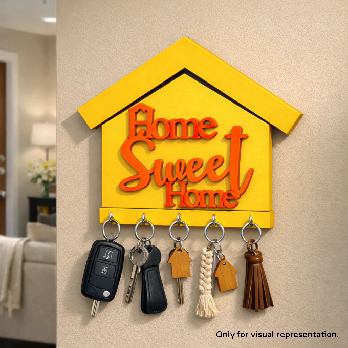 Yellow painted MDF  'Home Sweet Home' key holder with keys on a wall.