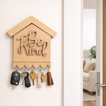 MDF key holder with 'Be Kind' text on a wall, featuring keys and a tassel.