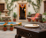 Decorative outdoor setting with a lit candle on a table, potted plants, and a fountain with diy mdf tealight candle holder