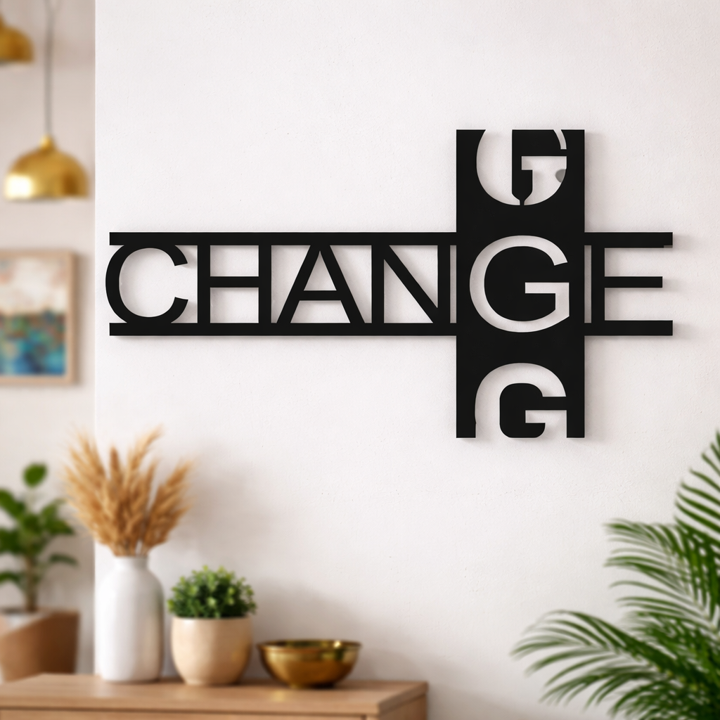 Modern black typography wall décor featuring the word “CHANGE” in a stylish geometric design mounted on a white wall in a contemporary living room setting.