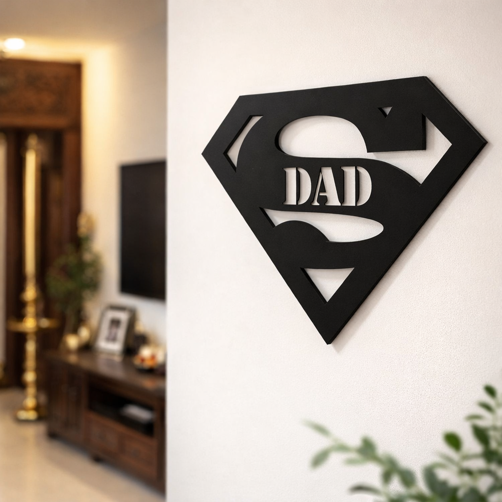 Black superhero-style “Super Dad” wall décor mounted on a white wall in a modern living room interior.