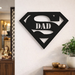Black superhero-style “Super Dad” wall décor mounted on a white wall in a modern living room interior.