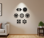 Seven chakra MDF wall decor set with spiritual symbols arranged symmetrically on a wall in a modern meditation space.