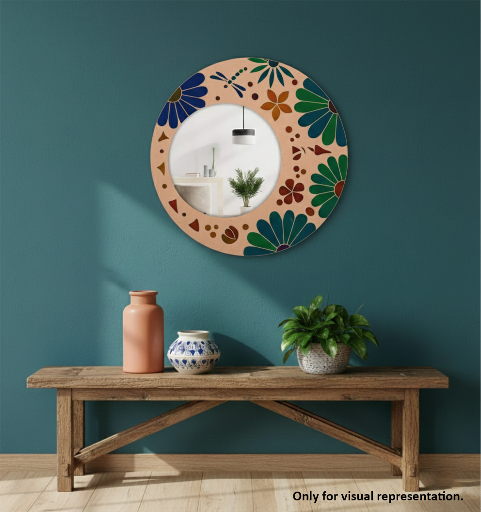 Decorative mirror with floral pattern on a teal wall above a wooden bench with vases and a plant.