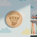 Plain MDF base with pre-marked design of a bear in a hot air balloon for DIY painting.