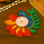 Decorative mdf candle holder shaped like a peacock with a lit candle on a wooden surface.