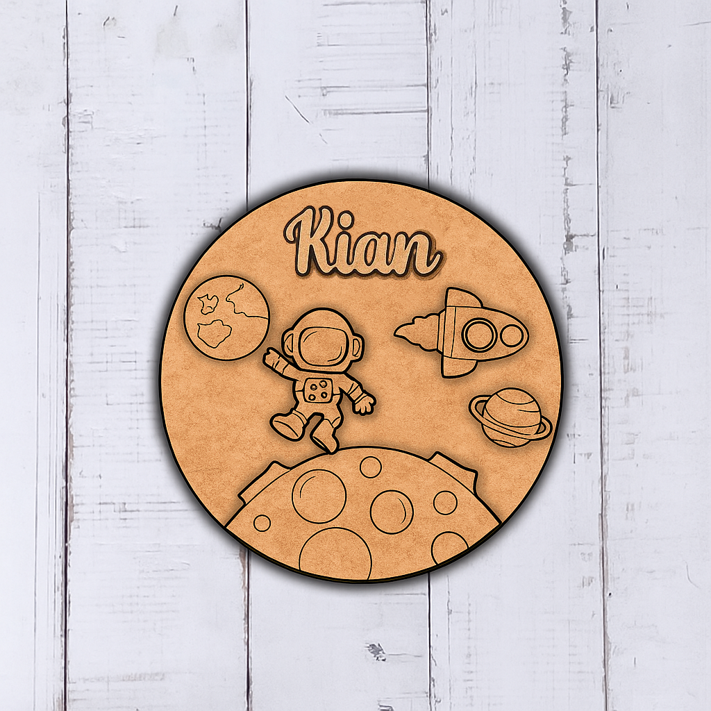 Round wooden cutout with space-themed design and 'Kian' engraved, on a light wooden background.