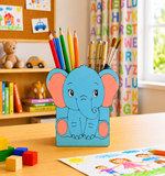 Children's desk with a MDF DIY  blue elephant pencil holder filled with colorful pencils, surrounded by toys and books.
