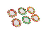 Set of colorful decorative circular clay diyas with intricate mirror detailing.