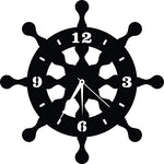 Black MDF wheel-shaped wall clock mounted on a rustic wooden panel wall, the enlarged picture of the product.