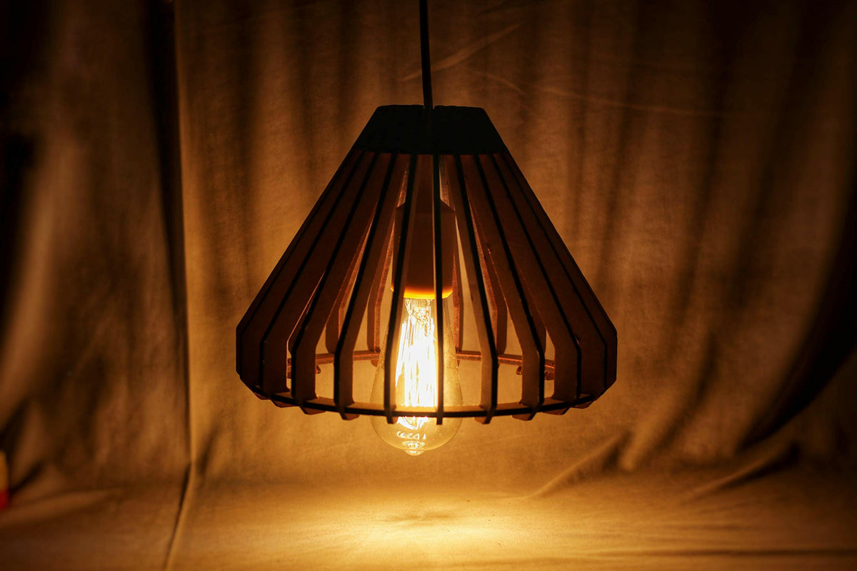 Matte black cage‑style ceiling pendant lamp with glowing Edison bulb and black hanging cord