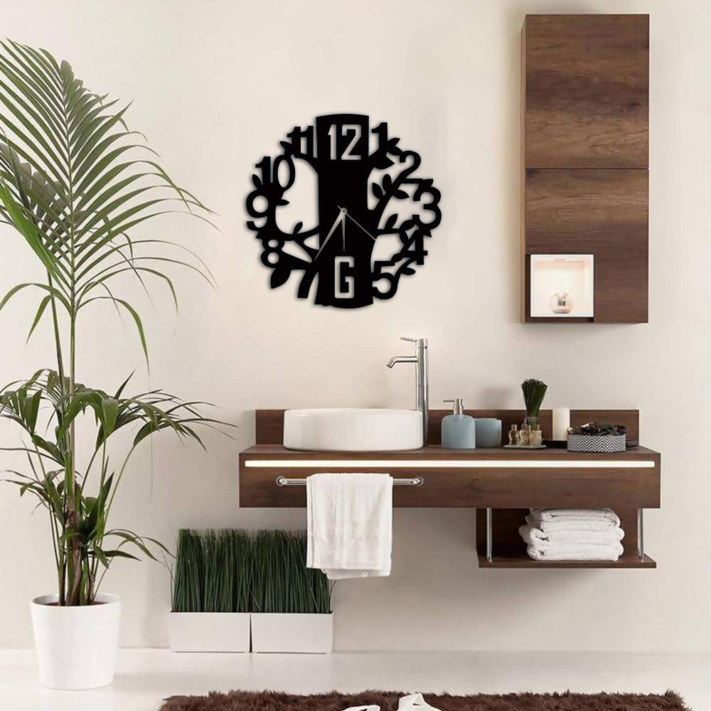 Round tree-shaped wall clock with intricate branch-inspired numerals, mounted above a modern bathroom vanity for a stylish and natural decor touch.