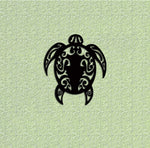 Intricate black MDF wall art of a tribal-style turtle design on a textured green background.