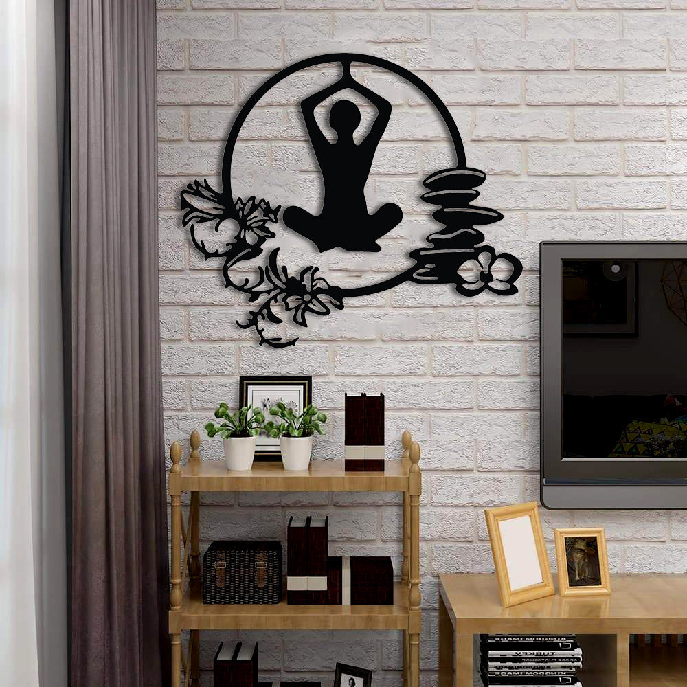 Yoga wall art featuring a meditative pose surrounded by floral accents and zen stones.