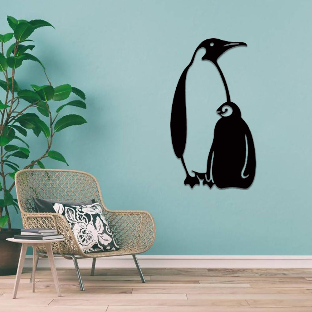 Minimalistic black penguin wall art decor on a teal wall in a cozy living room setup.