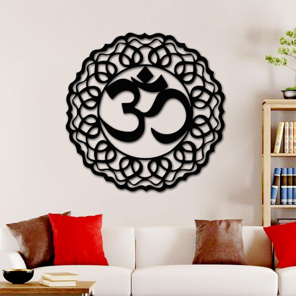 Black Om sign wall art featuring intricate circular patterns, mounted on a beige wall above a sofa in a modern living space, ideal for mandir decor.