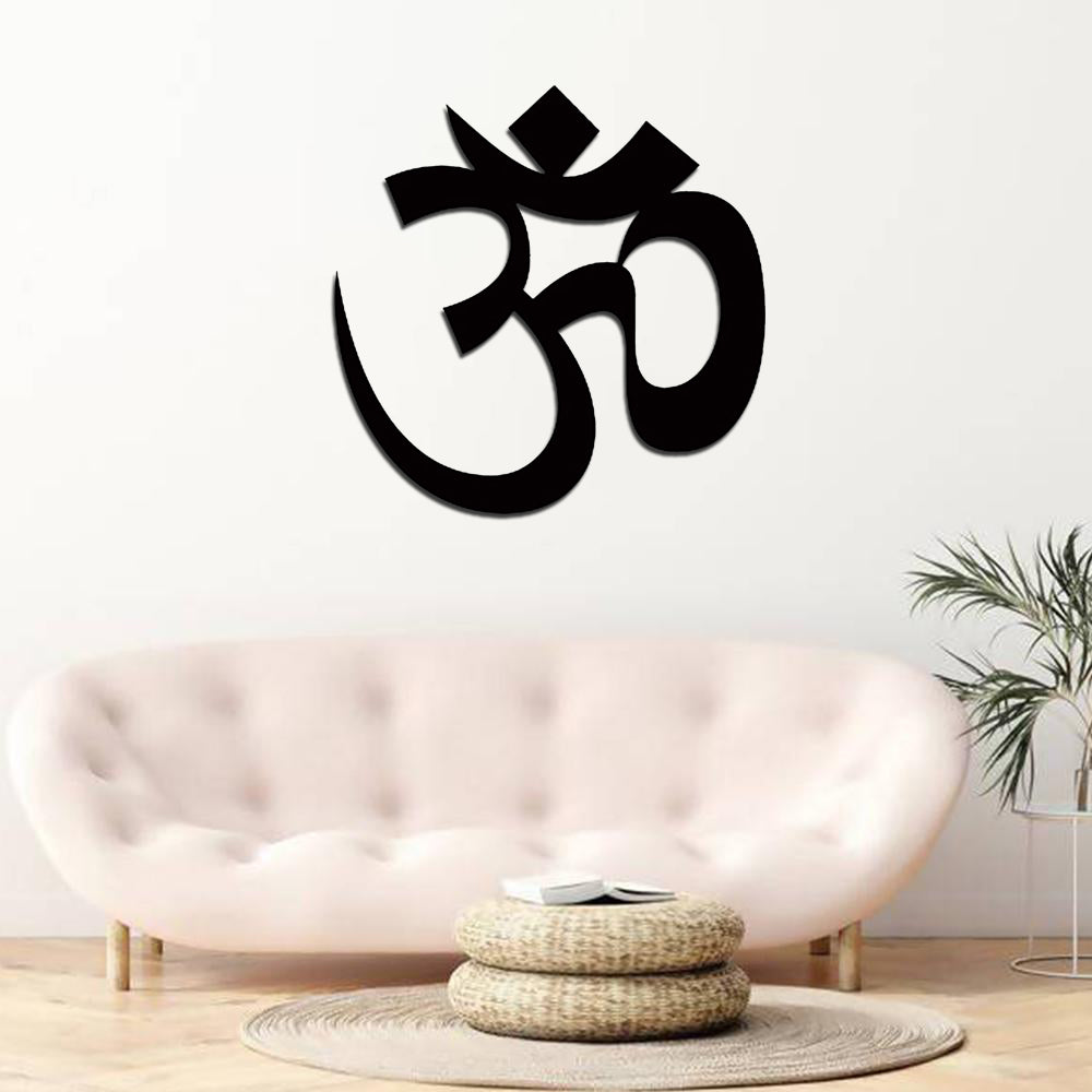 Black Om symbol wall art displayed above a modern beige sofa in a minimalist living room.