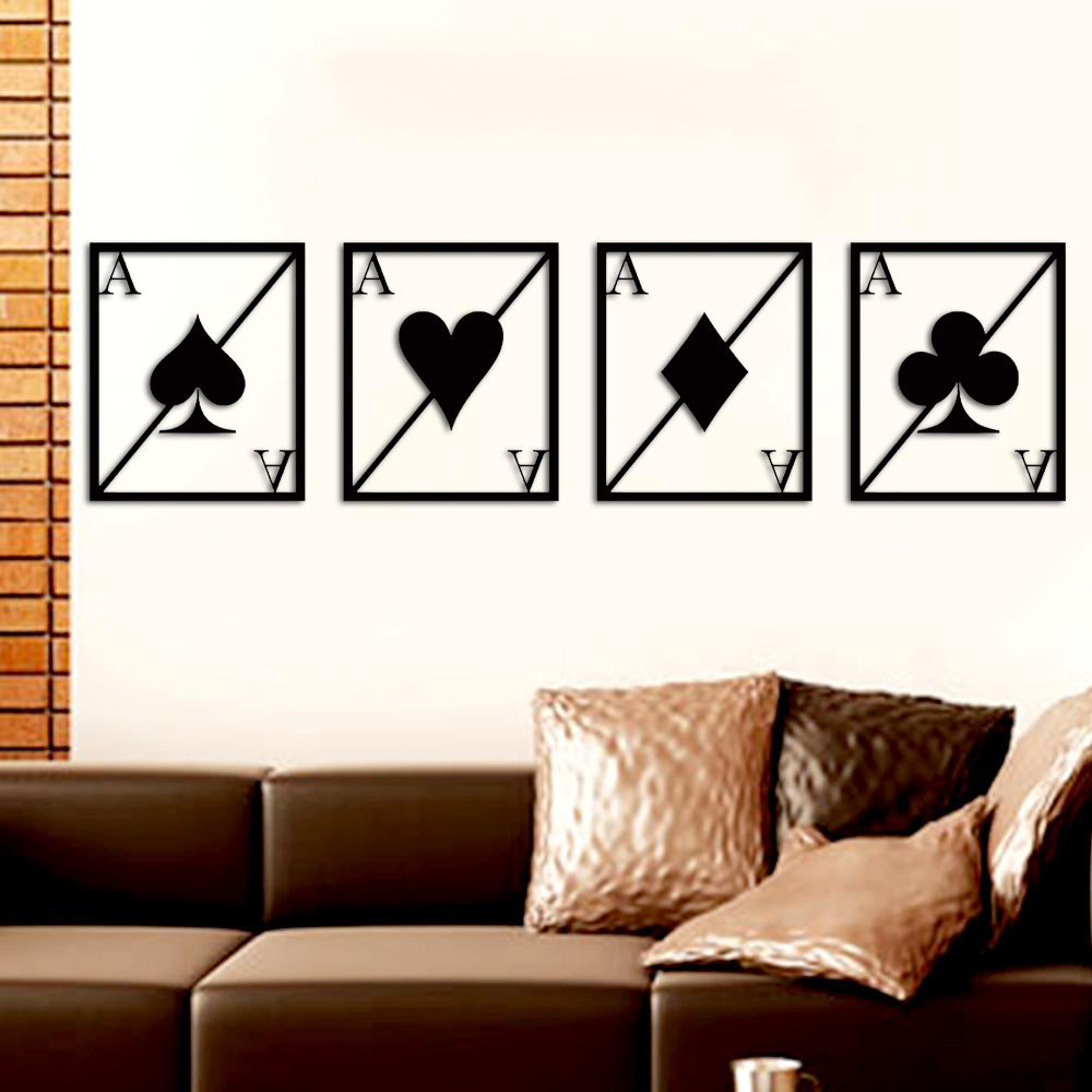 Set of four black MDF wall art pieces featuring playing card symbols (spade, heart, diamond, club) with "A" for Ace in a minimalist design, mounted on a beige wall above a modern sofa.