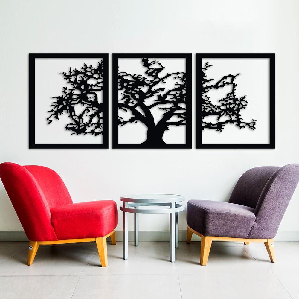 Triptych wall art featuring a black silhouette of a tree spread across three panels, mounted on a white wall above a seating area with red and purple chairs.