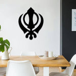 Black MDF Khalsa symbol wall decor piece mounted on a white dining room wall.