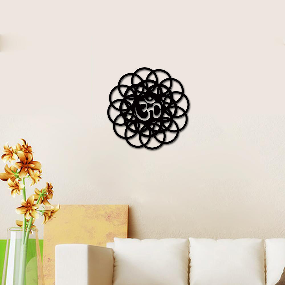 Intricate black Om wall art with a floral circular design displayed in a peaceful living room setting.