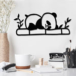 Adorable black MDF panda wall decor featuring a sleeping panda on bamboo with leaves, adding a playful and cozy touch to any space.