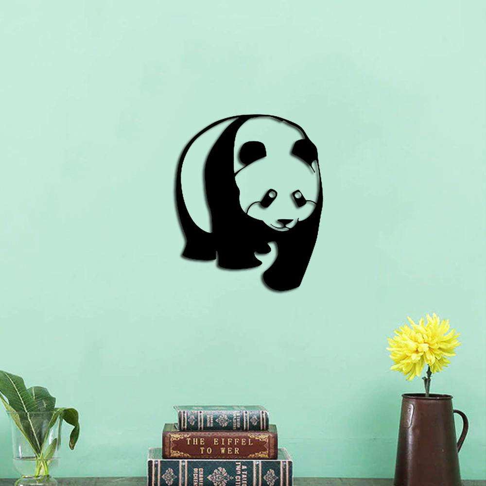 Minimalist MDF panda wall decor mounted on a light green wall, styled above a bookshelf and vase.