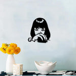 Black anime girl wall art featuring a stylized silhouette of a girl with intense eyes and bangs, mounted on a light blue wall above a console with decorative items.