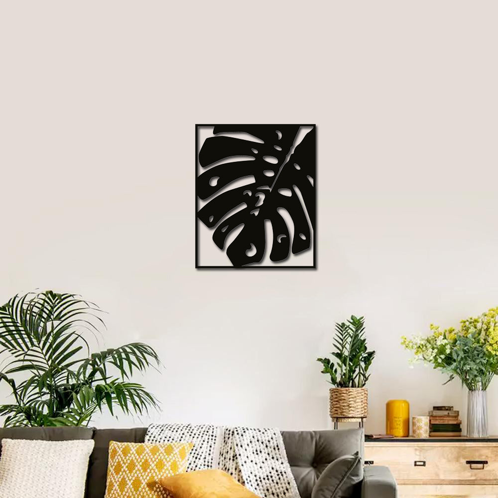 Elegant black palm design wall art displayed in a cozy living room with natural decor accents.