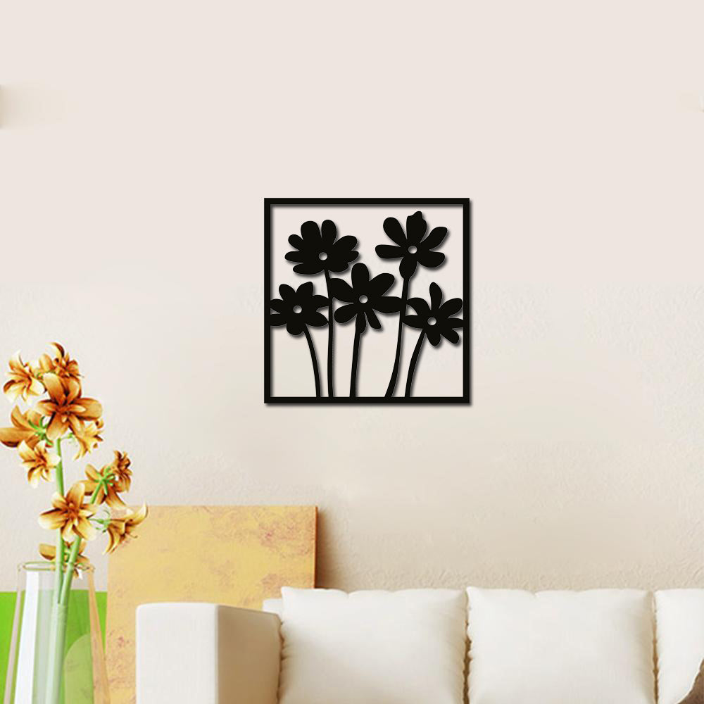 Black flower wall decor featuring a minimalist floral design, mounted on a light-colored wall above a cozy living room setup.
