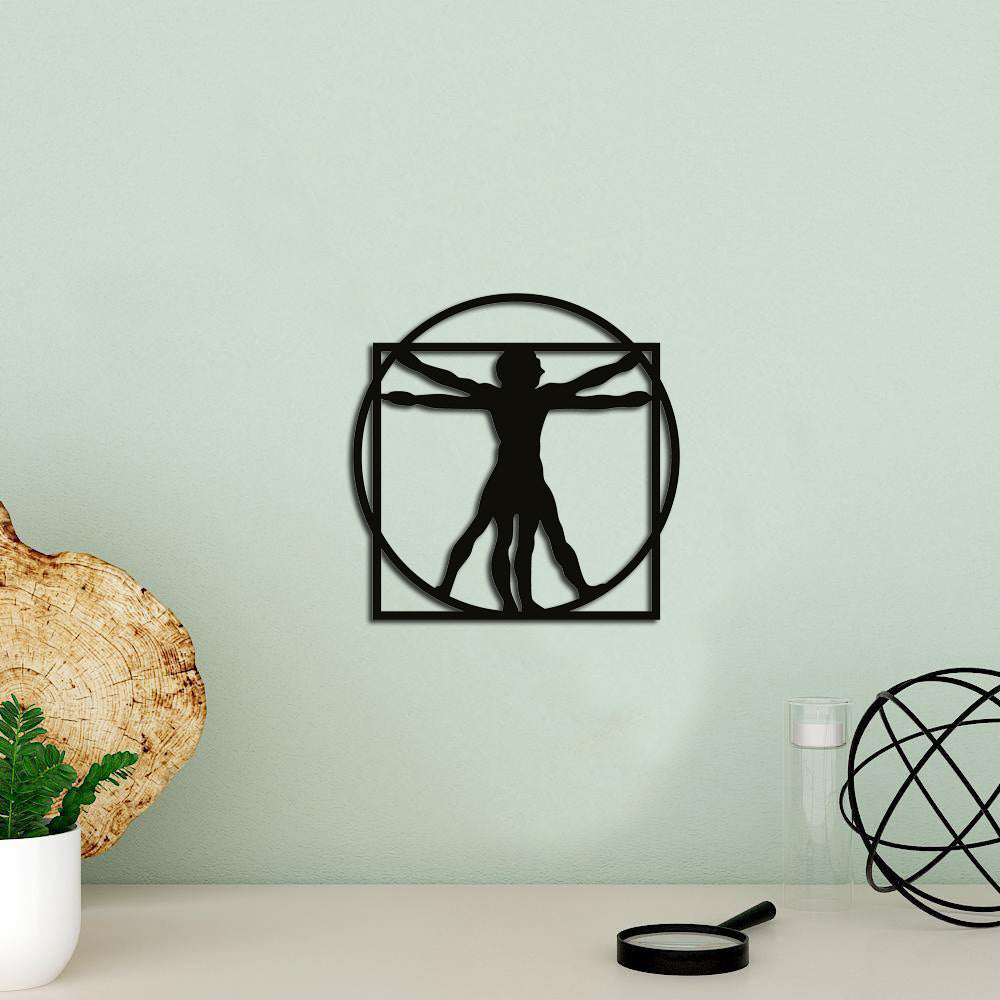 MDF Vitruvian Man wall decor inspired by Leonardo da Vinci's artwork, mounted on a light green wall with minimalist decor accents