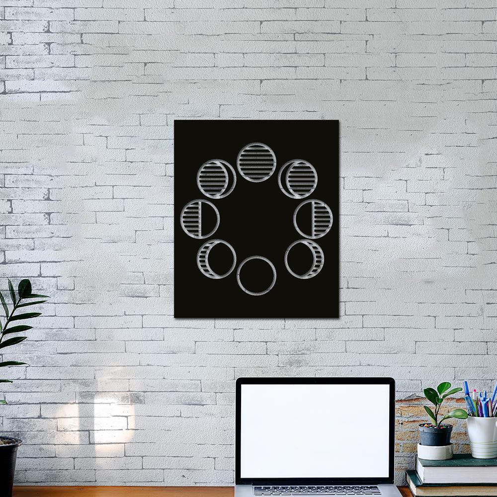 Minimalistic phases of the moon wall art decor displayed on a white brick wall above a desk setup. 