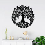 Round black wall art featuring an intricate tree of life design with Celtic-inspired roots and branches, mounted above a white cabinet.